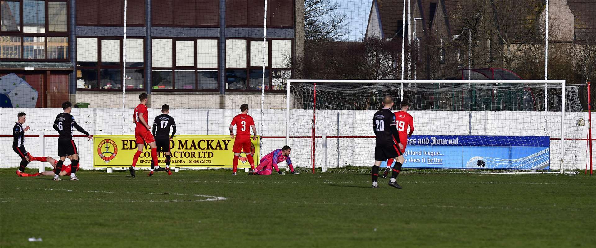 Steven Anderson (left) watches as his shot beats Brora keeper Joe Malin to give Wick Academy a 10th-minute lead. Picture: Mel Roger