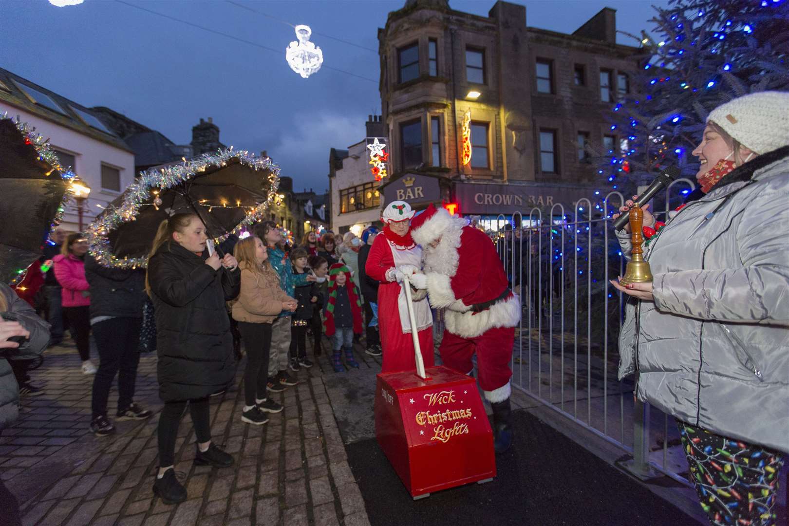 Santa and Mrs Claus switch on the Wick Christmas Lights, as Claire Mackenzie, (right), chairwoman of the lights committee looks on. Picture: Robert MacDonald/Northern Studios