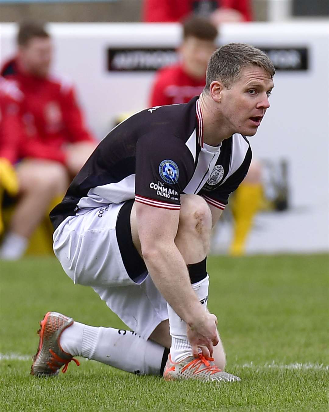 Davie Allan tying a bootlace during the match at Inverurie last April in which he was later injured. Picture: Mel Roger