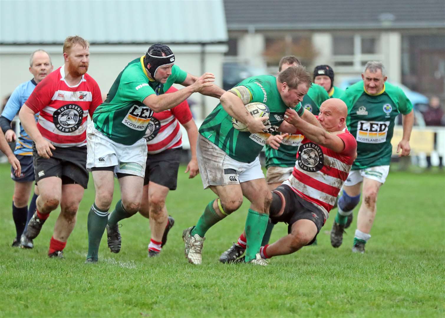 Tom McGee (Caithness Evergreens) tries to break free, backed up by Andy Morris. Picture: James Gunn