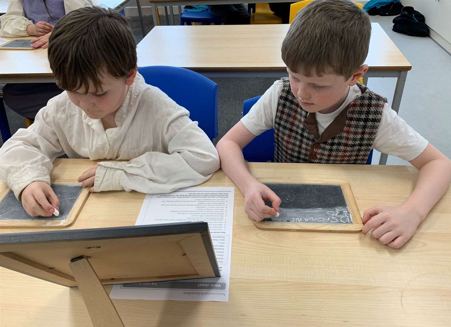 P5 pupils Logan Will (left) and Seumas Kerr concentrate hard on calculations involving Victorian money.
