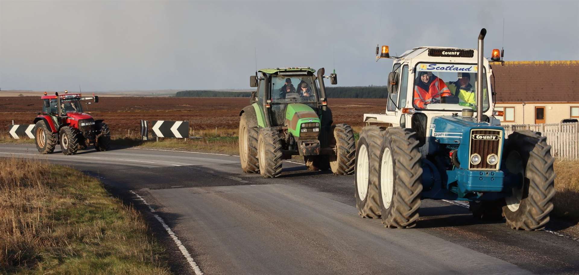 Some of the tractors making their way across the Killimster Moss road as they head back to Quoys of Reiss. Picture: Neil Buchan