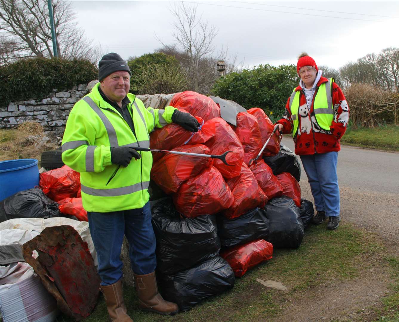John and Kathleen Gunn with some of the 100 bags of rubbish they collected on a 15-mile stretch of the A9 from the Ord to Latheronwheel during March. Picture: Willie Mackay