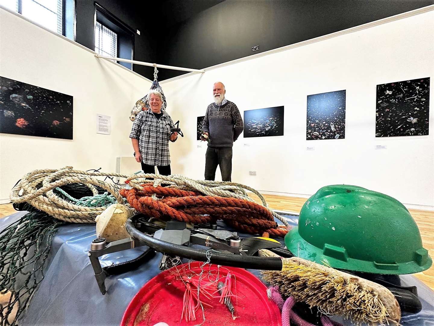 Dorcas Sinclair (left) and her husband Allan (right) at Thurso Library and Art Gallery today checking out the award-winning photographer Mandy Barker's Our Plastic Ocean exhibition.