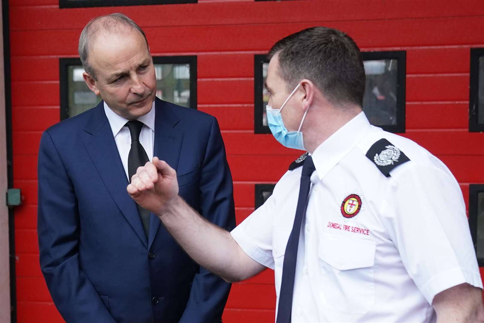 Taoiseach Micheal Martin meets firefighter Kevin Boylan at Letterkenny fire station (Brian Lawless/PA)