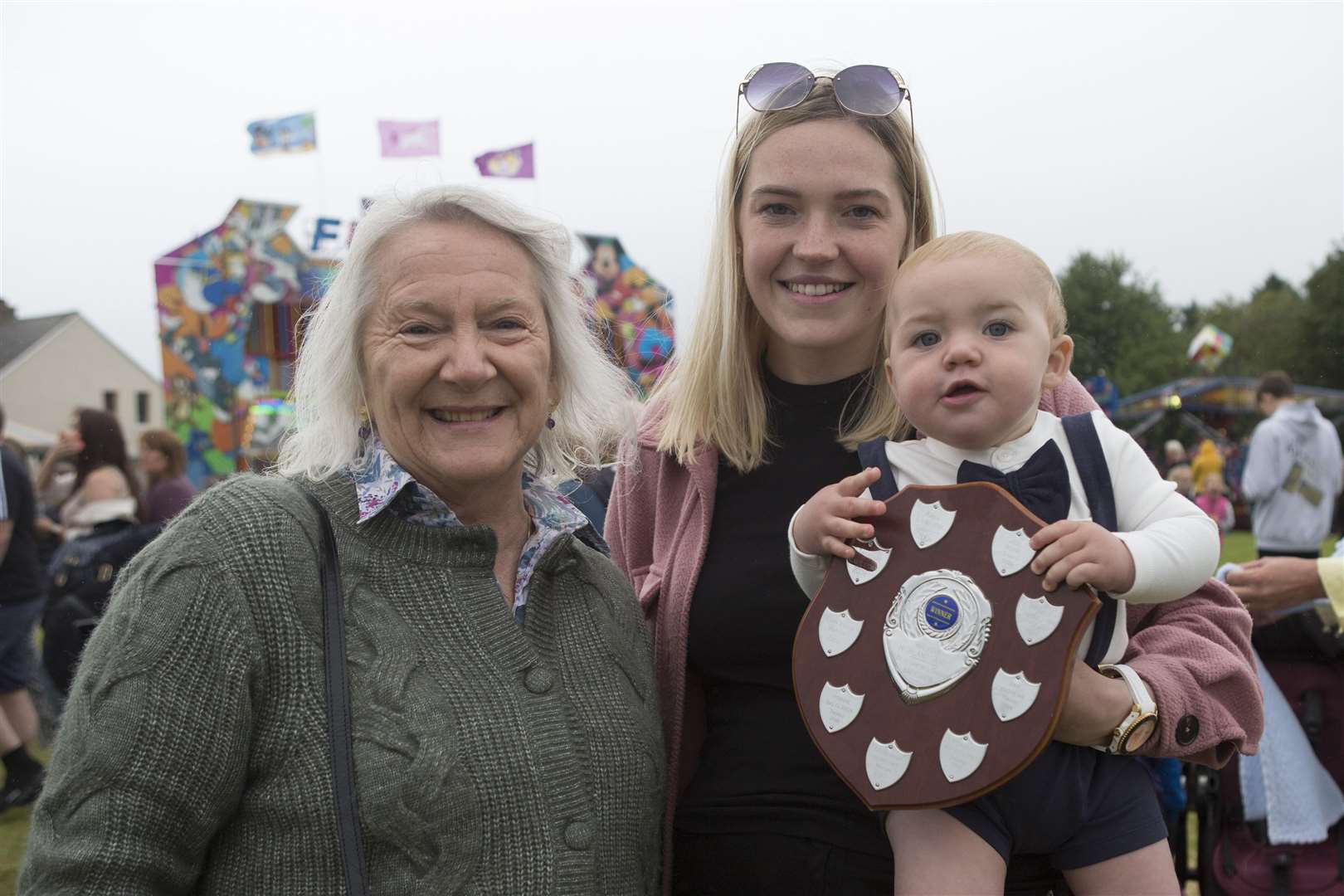Ten-month-old Brody Henderson, from Hempriggs, won the baby show. He is seen here with his mum Zoe Harris and judge Lady Marion Thurso. Picture: Robert MacDonald/Northern Studios