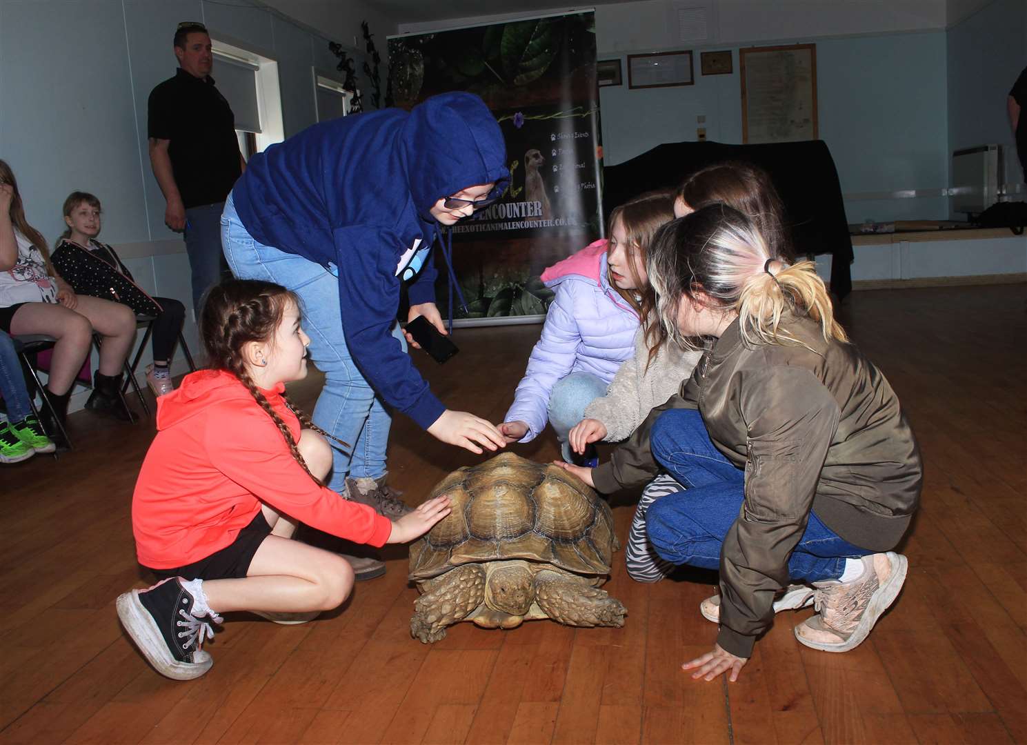 Some of the Klics children saying hello to the sulcata tortoise.