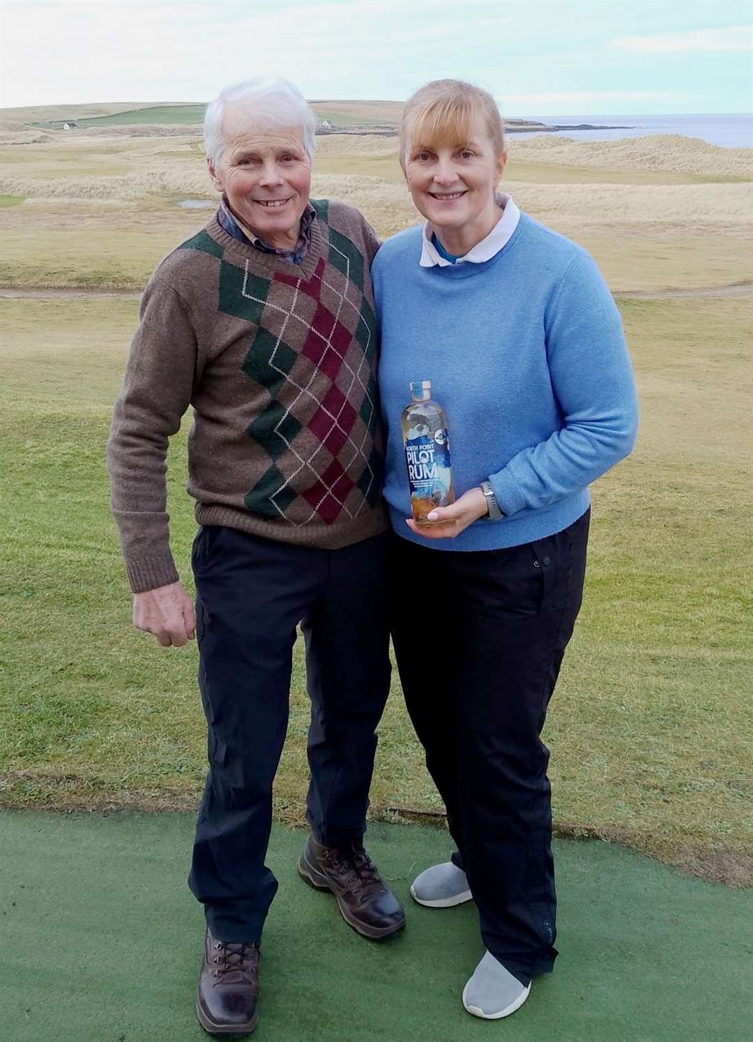 Carol Paterson, winner of the nearest-the-pin prize in the latest round of the North Point Distillery Senior Stableford, with senior section convener Sandy Chisholm.