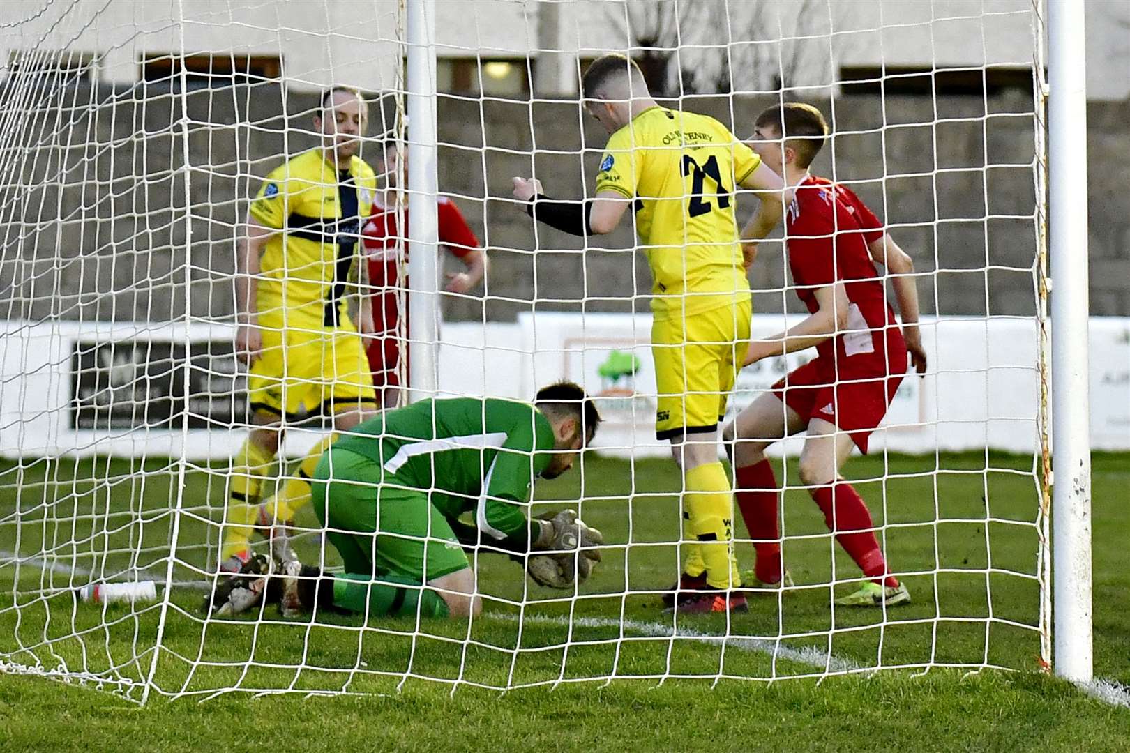 Wick Academy goalkeeper Gordon Clark pulls off a last-ditch save on the line to deny Lossiemouth's Jack Gordon during the 2-0 victory at Grant Park. Picture: Mel Roger