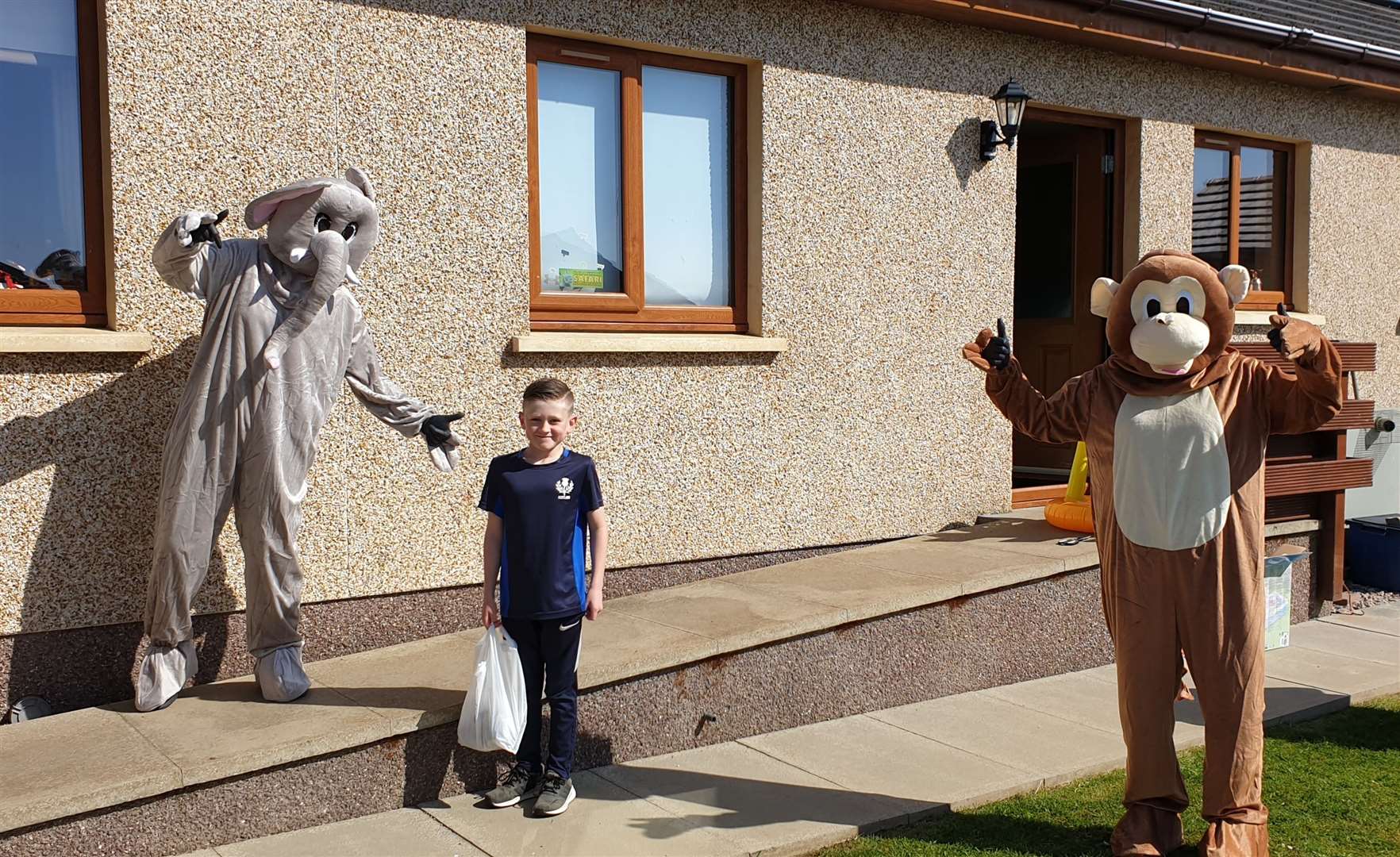 Eight-year-old Connor MacLeod, who benefits from the service due to his mum Shelley's health issues, pictured here with Caithness Klics team members – project manager Wendy Thain, Connor's granny, dressed up as an elephant, and fieldworker Zoe Sutherland in the monkey outfit.