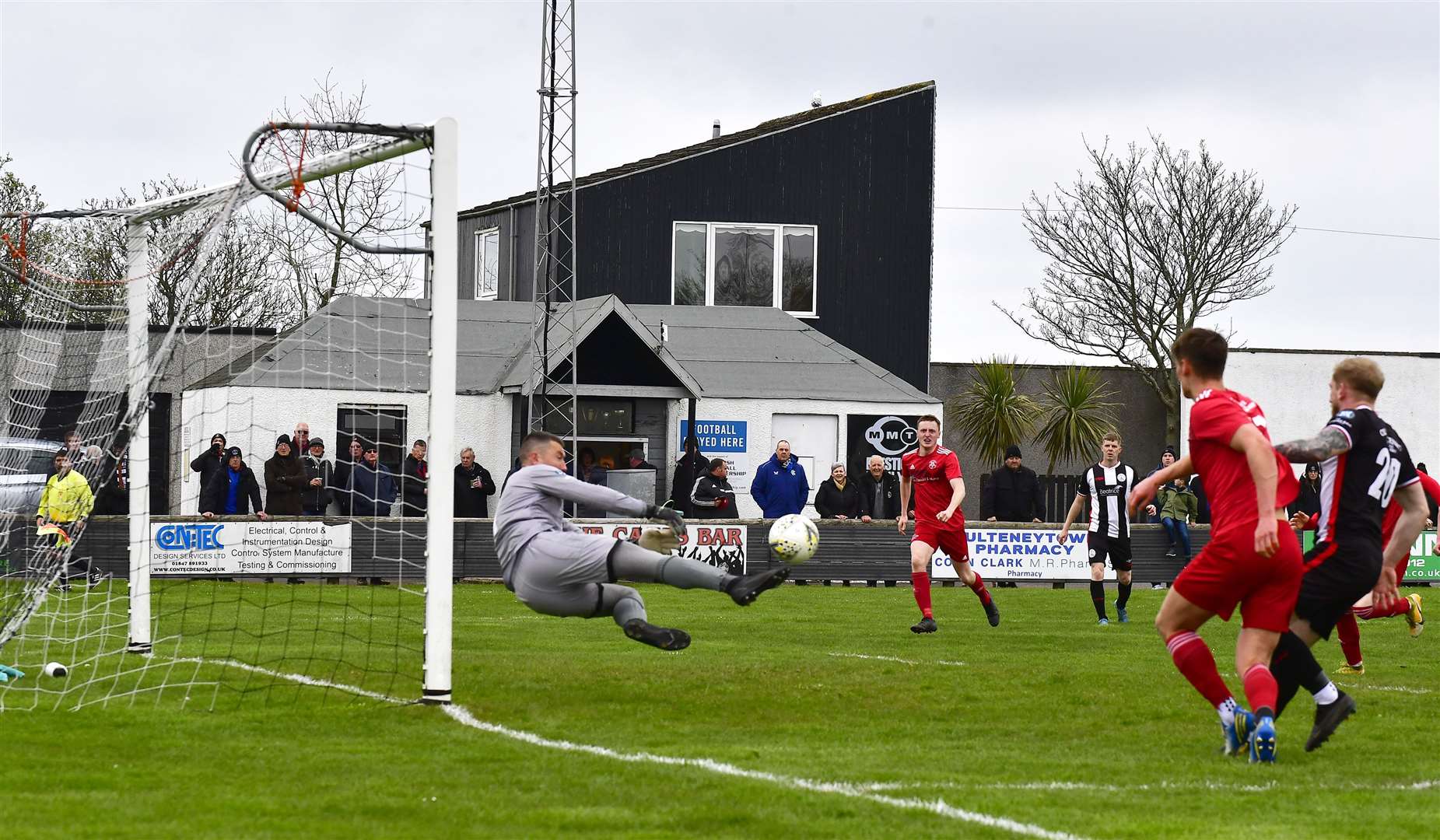 Wick Academy keeper Graeme Williamson pulls off an acrobatic save to deny Lossiemouth. Picture: Mel Roger