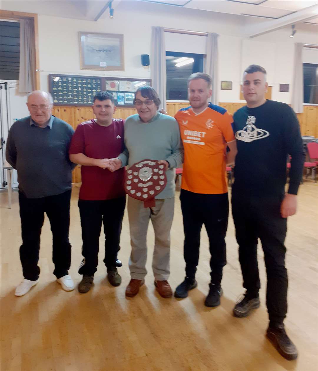 Sponsor Ian Maclean (centre) presents the Forss Open Triples Shield to the winning Scrabster team of Scott Christie, Ross Cowan and Ian Mackay, with chairman John Macdonald (left) looking on.