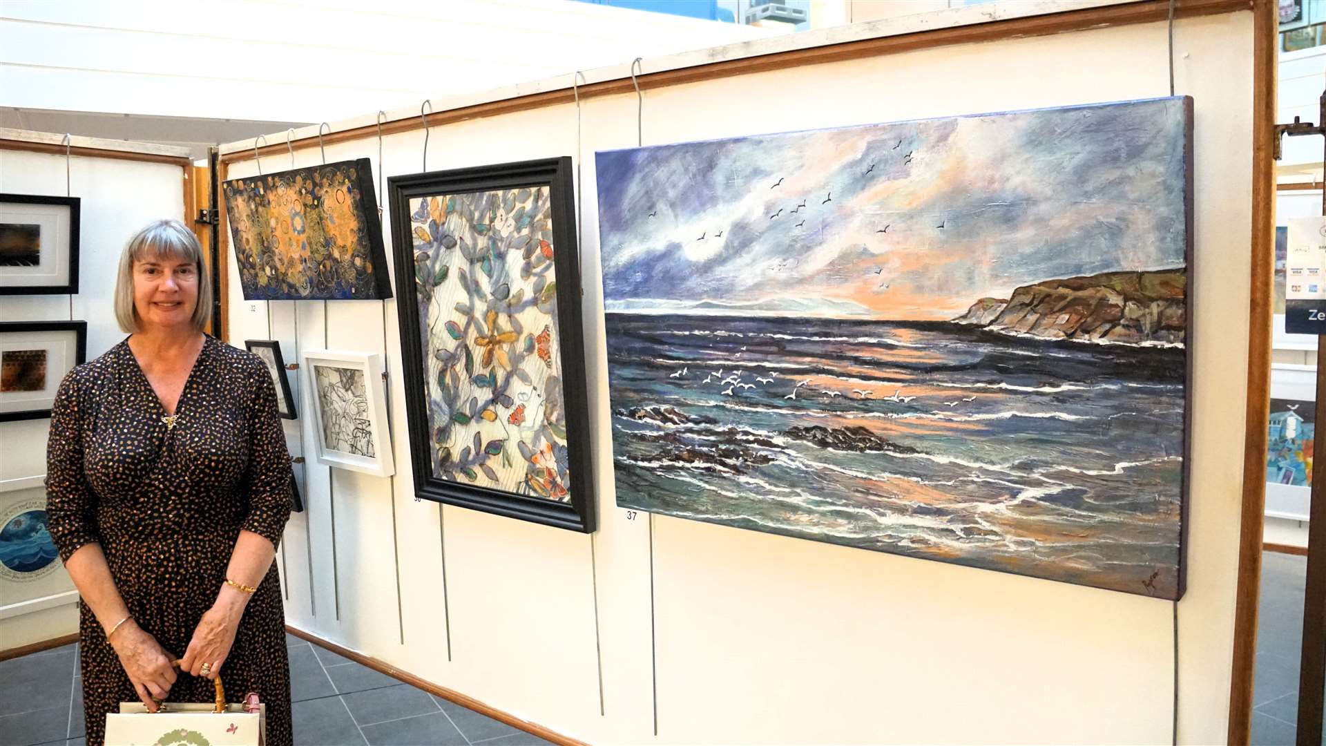 Elaine Rapson-Grant is a regular at the Thurso art show. She talked about the painting on the right called 'Sing with the Gulls'. Picture: DGS