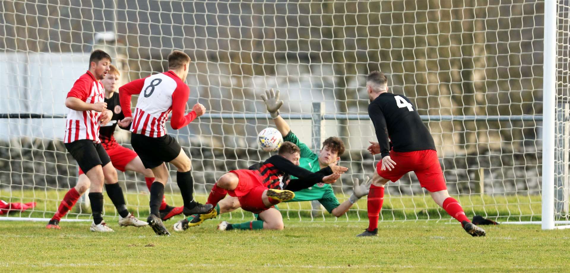 Cammy Mackintosh puts St Duthus ahead despite best efforts of keeper Lewis Gallacher and defender Korbyn Cameron. Picture: James Gunn