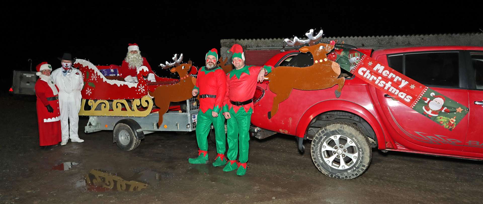 The Milton Mob ready to set off with Fiona Budge as Mrs Claus, Alec Budge (snowman) the driver and Alastair Budge as Santa along with elves Mark Budge and Iain Mackenzie. Picture: James Gunn