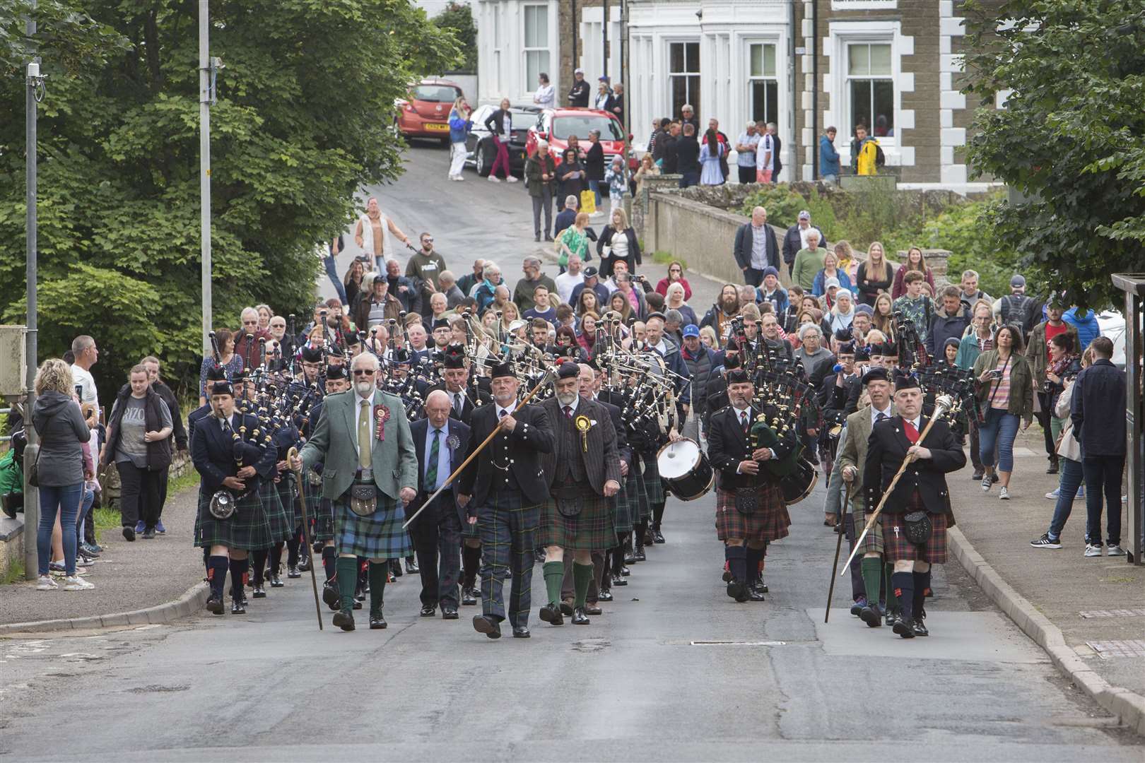Halkirk Highland Games chieftain Lord Thurso, (front centre right) and president Alistair Swanson, (front centre left), lead the massed pipebands, followed by supporters on the march from the village to the games field. Photo: Robert MacDonald/Northern Studios
