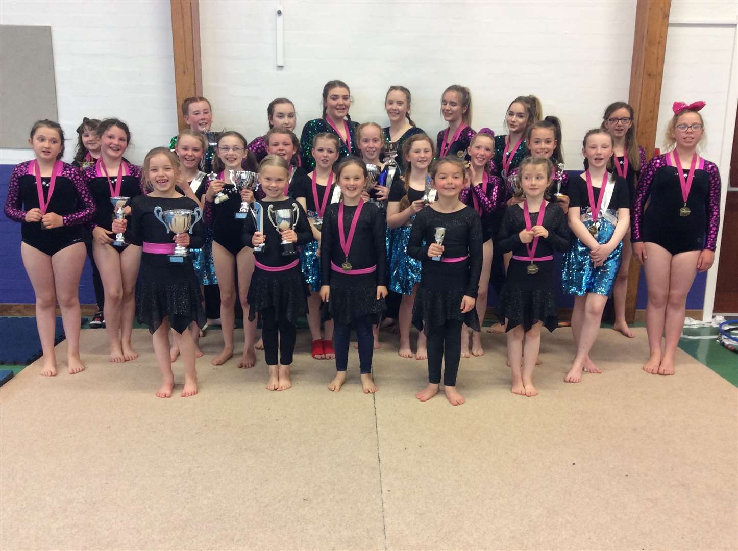 Gymnasts with their trophies and medals.