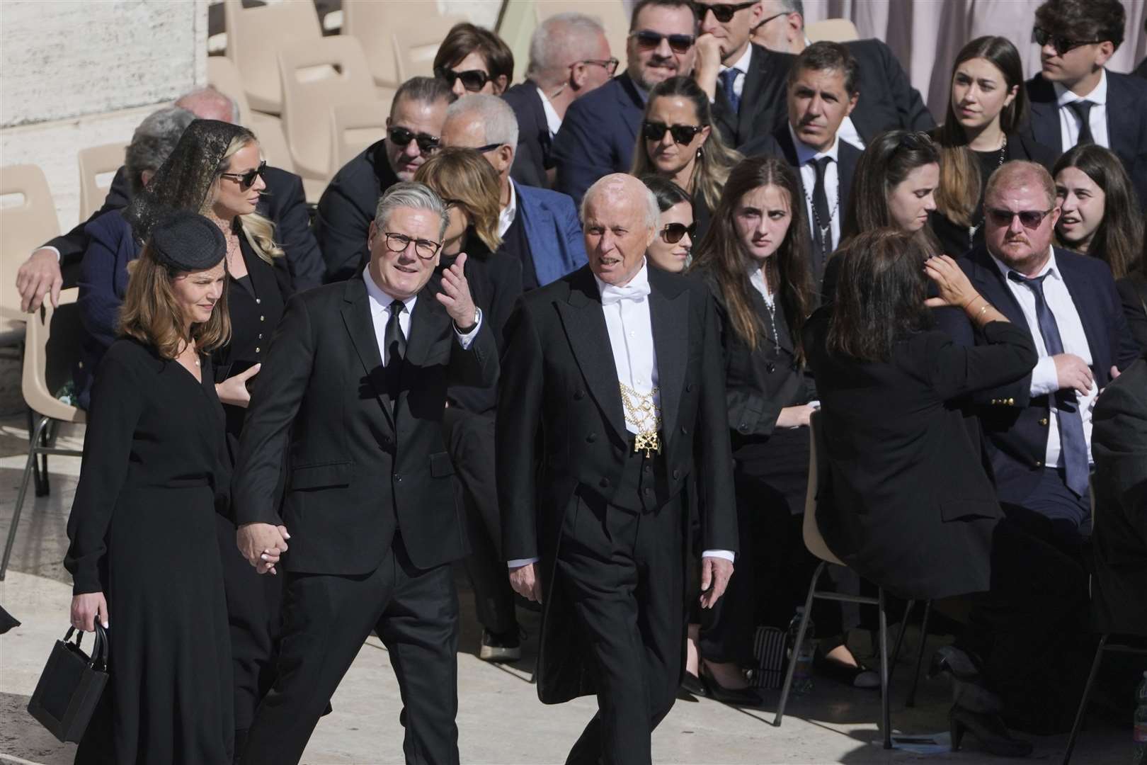 Sir Keir Starmer and his wife Victoria, Lady Starmer, are guided to their seats in St Peter’s Square (Markus Schreiber/AP)