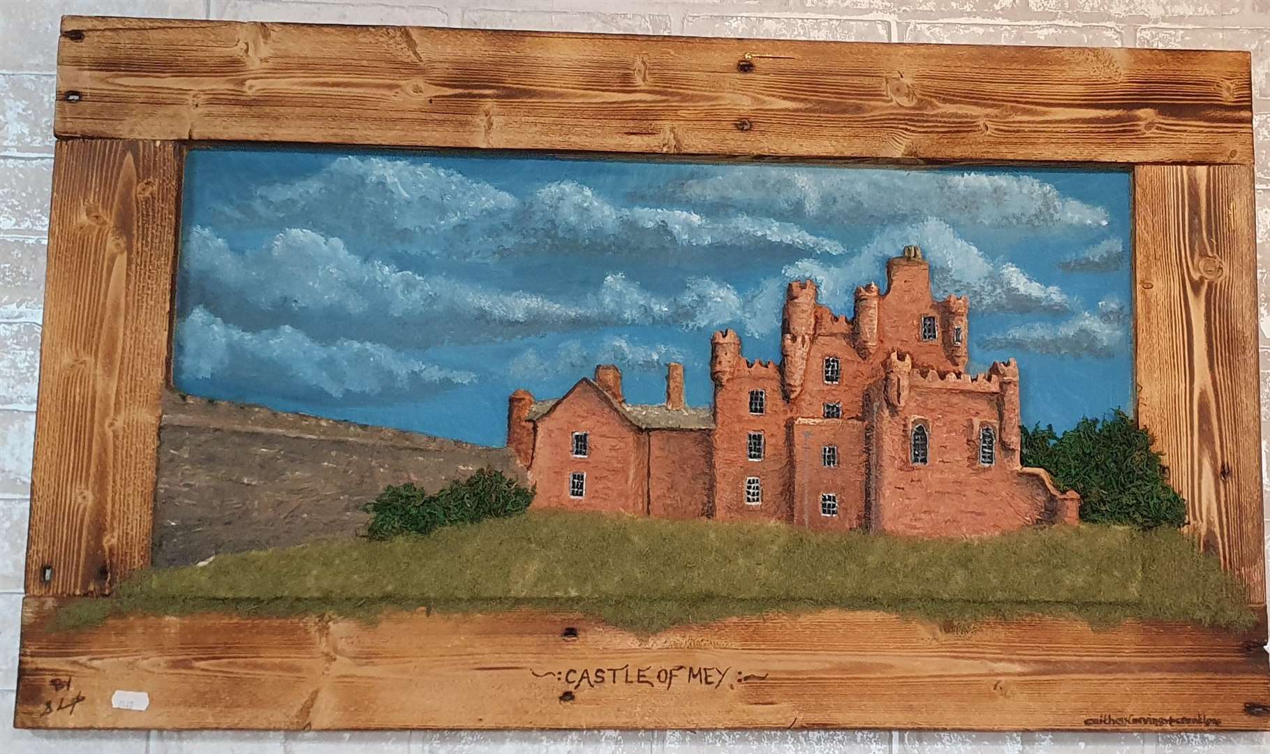 Castle of Mey by Scott Livingstone of Caithness Carvings and Creations.  He specializes in hand carved Caithness stone images, house names/numbers and table lamps.  3D images of buildings or landscapes and the odd furniture with a 10,000V wood burner and any color resin, all made to order.