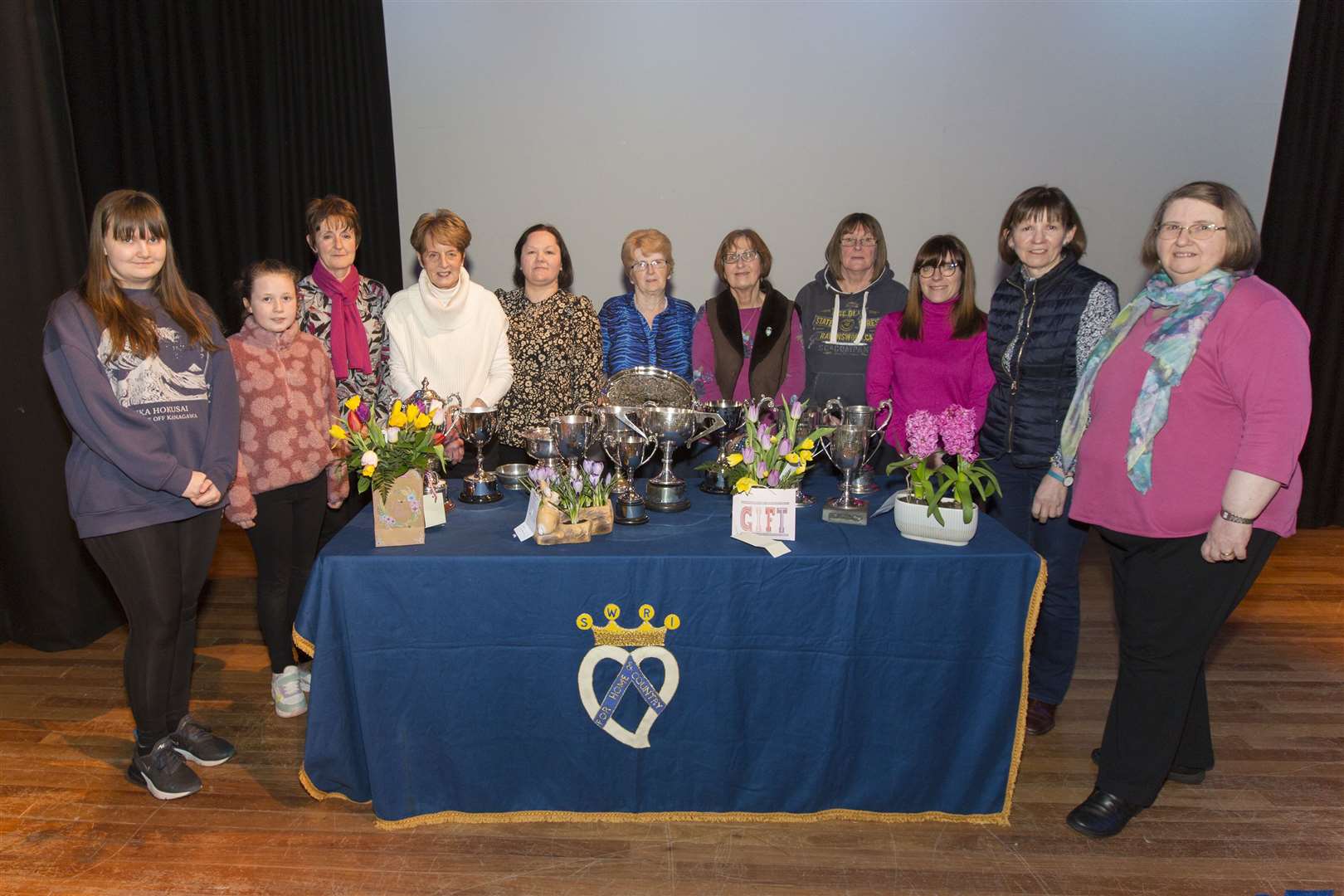 Trophy winners from the East of Caithness SWI bulb show along with Lysette Butler (right), the Caithness SWI Federation chairwoman, who handed over the trophies following the annual event in the Wick Assembly Rooms. From left: Aimee Lowe, Keiss, who shared the junior trophy for most points in bulbs with Lily Richard, Killimster, who wasn't present, Ella Miller, Thrumster, junior most points in handicrafts and baking, Anne Sutherland, Latheron, who won the trophies for crocuses and two hyacinths, Gladys Gunn, Mid Clyth, best exhibit in bulbs, four daffodils, and best amaryllis, Lynn Hendry, Latheron, most points senior handicrafts, Kathleen Baikie, Thrumster, four tulips, Sue Steven, Berriedale, three hyacinths, Shona Sinclair, who collected the trophy for the institute with 16-24 members on behalf of Latheron, Julie Murray, who collected the trophy for the institute with 15 or less members on behalf of Killimster and Carol Grant, Latheron who had most points in bulbs and most points overall. Picture: Robert MacDonald/Northern Studios