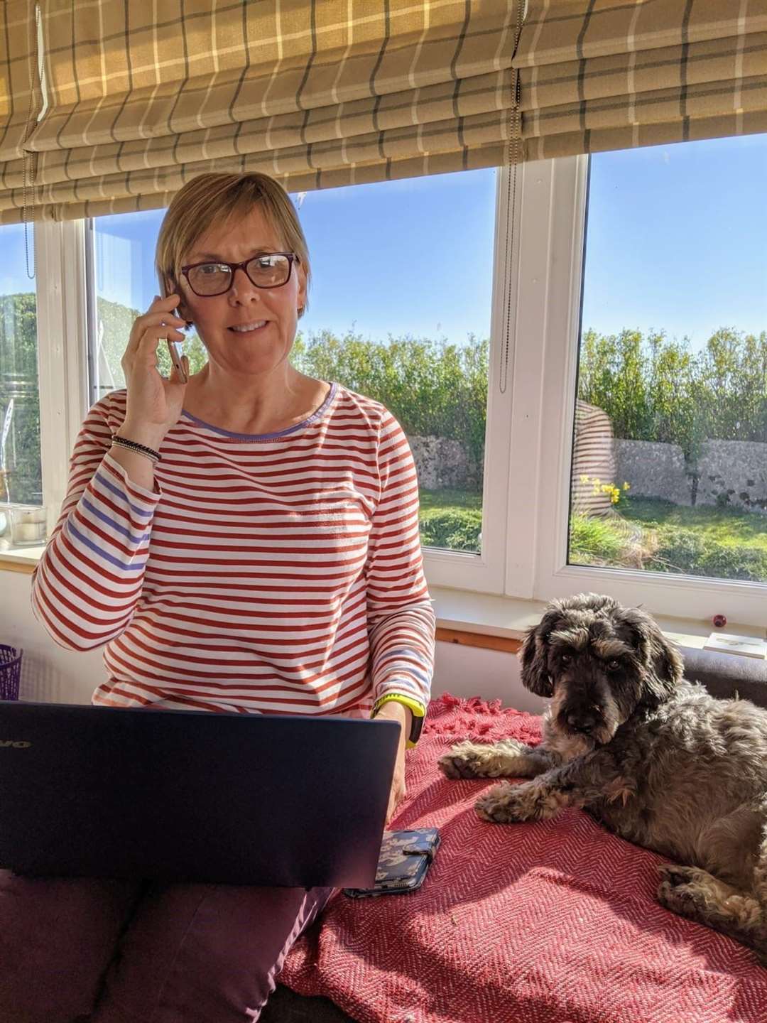 Assistant befriending co-ordinator Elspeth Manson making a call for Befriending Caithness, with family pet Ollie looking on.