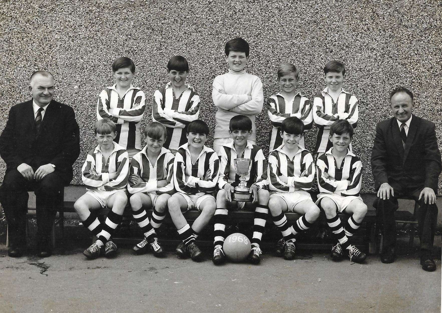 Pulteneytown Academy football team, 1968. Back, left to right: John Durrand, Freddie Hay, William Innes, Hamish Robertson, Alistair Miller; front: Donald Campbell, ?, Alan Mackay, David Manson (Captain), Ernest Barnes, William Innes. Mr Alex Henderson, the head master, sits on the left with the janitor, Mr Mackie, on the right. (David Manson)