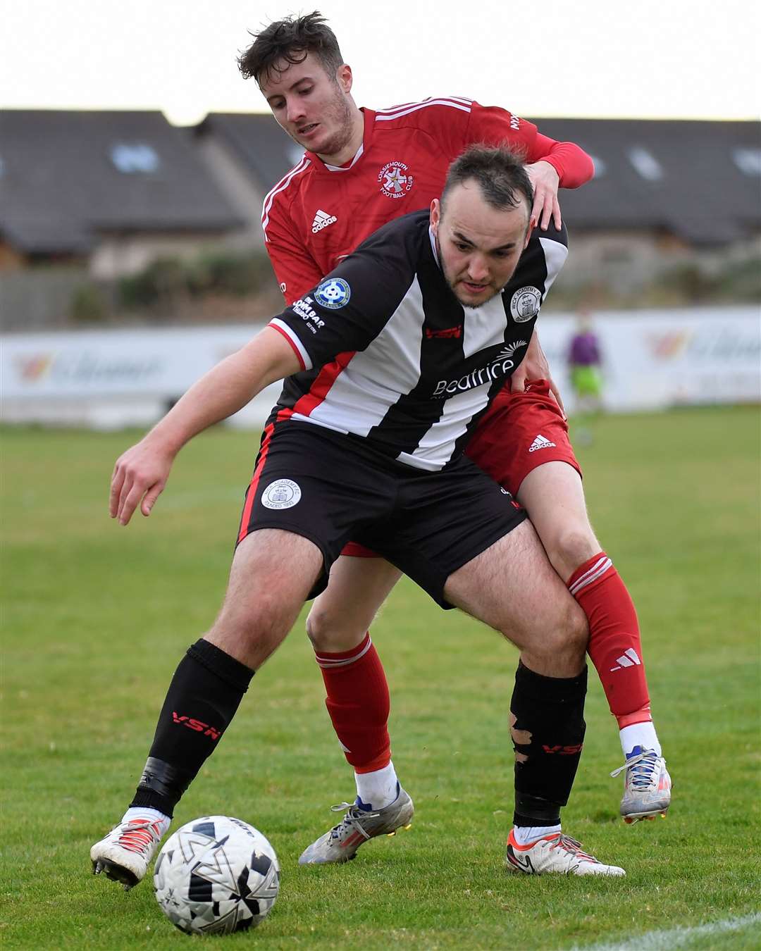 Owen Harrold holds off a challenge from Lossiemouth's Ross Morrison. Picture: Mel Roger