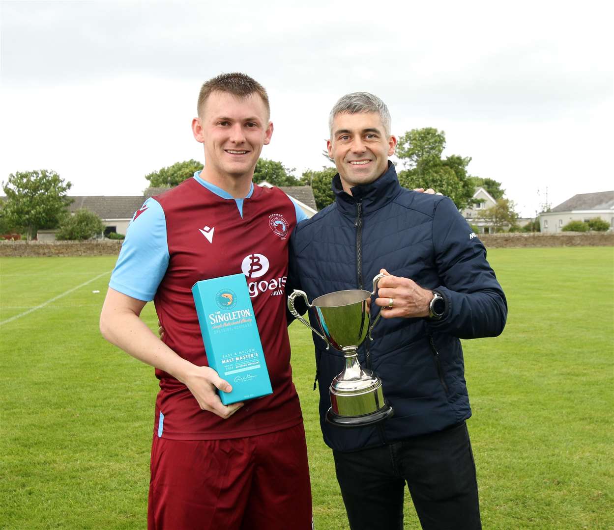 Pentland United captain Andrew Mackay with Colin Macleod's son Greg. Picture: James Gunn
