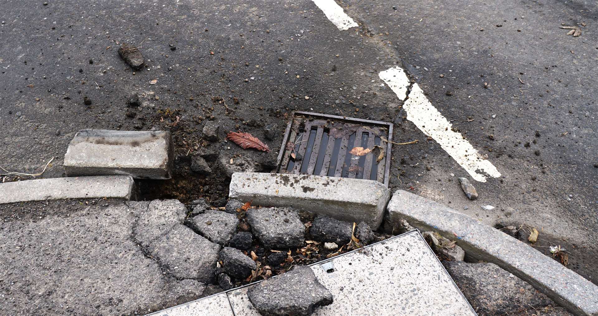 The drain, though recently cleared out, is now full and may be damaged. Kerbstones are knocked out and the pavement is in pieces. There is a BT broadband cover beside the damaged area. Picture: DGS