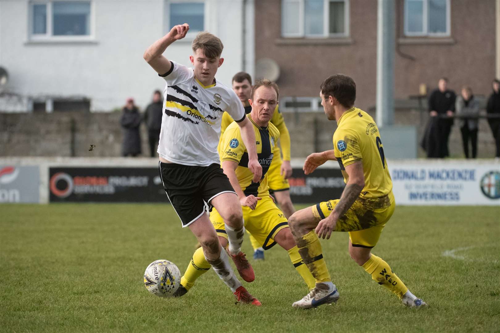 James Anderson (Clach) goes past Jack Henry (Wick Academy). Picture: Callum Mackay