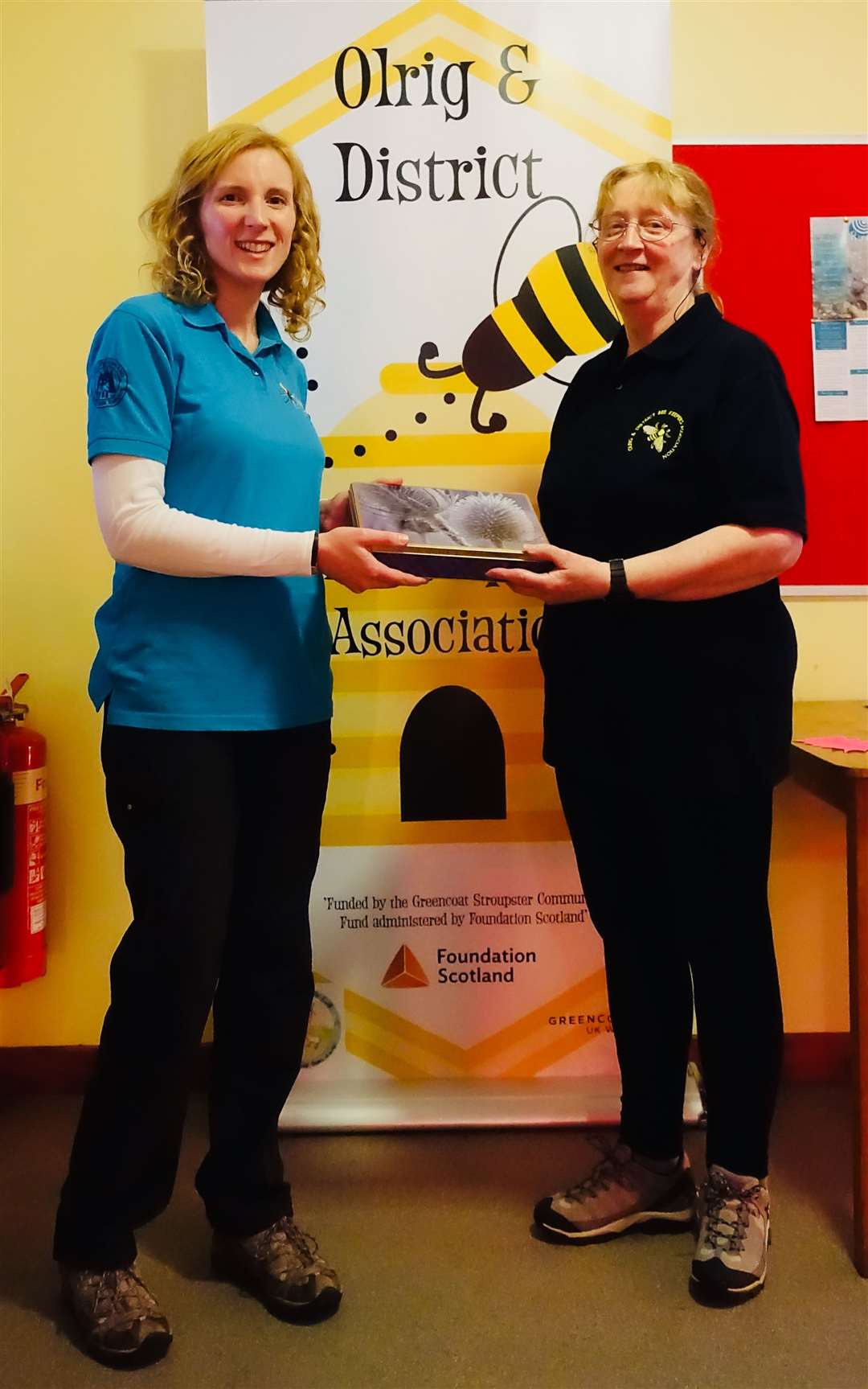 High Life Highland countryside ranger Kirsty Rosie receiving a tin of home baking from Anne Bertram, secretary of the Olrig and District Beekeepers Association.