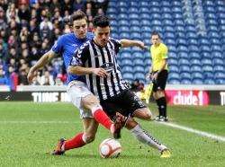 Daniel Moore evades a tackle by Andy Little. Photo by Bob Crombie.