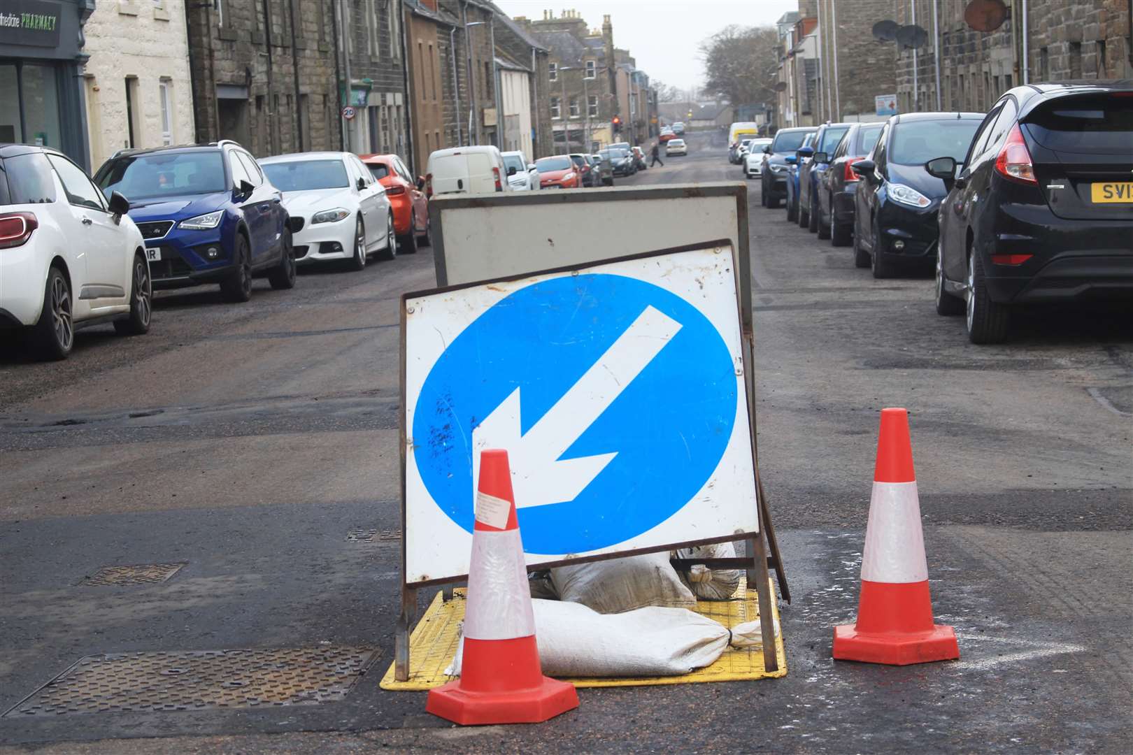 The hole in Dempster Street has been covered up, with traffic cones and 'keep left' signs positioned beside it.