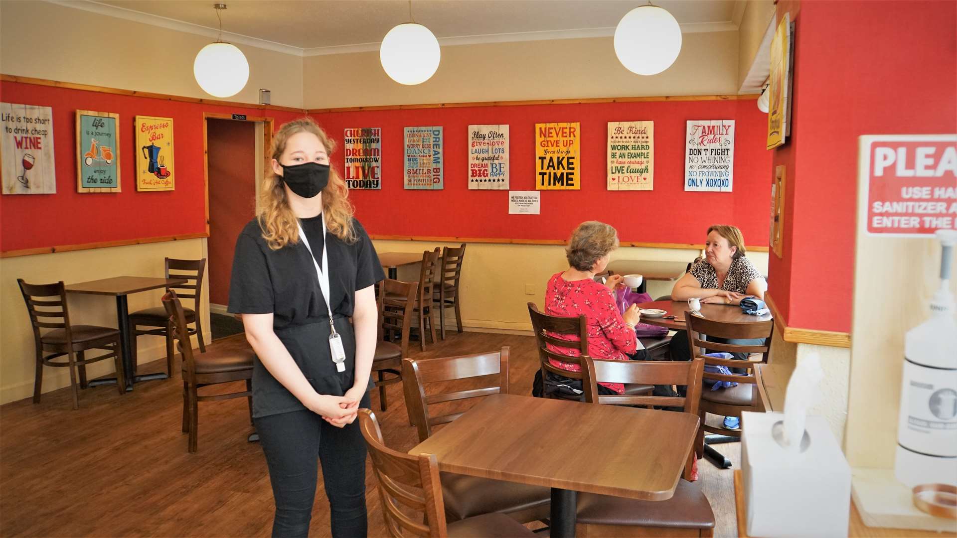 Morag's café on Wick's High Street is open to seated customers again as employee Ruby Stickells prepares to take orders.