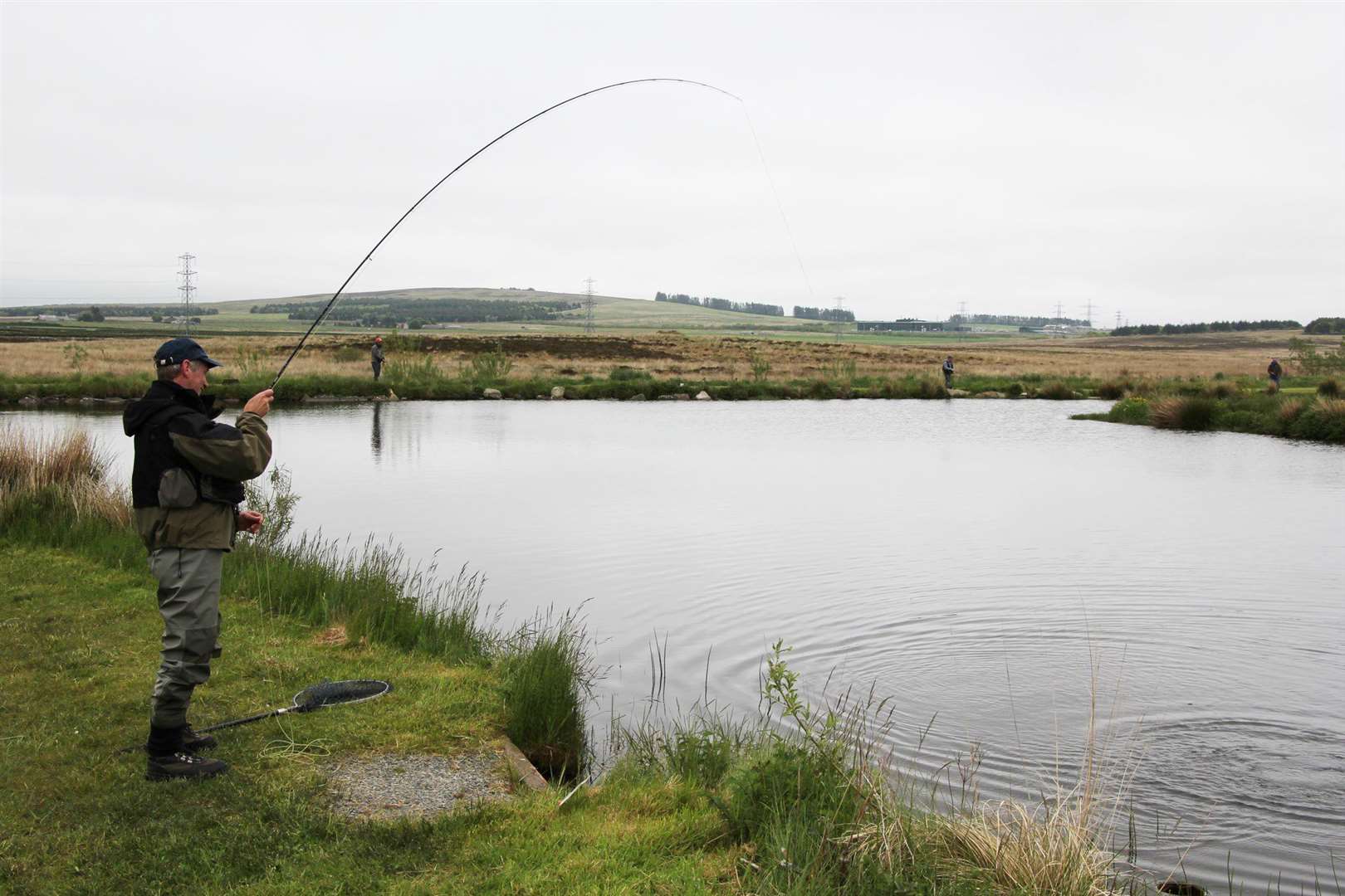 Willie Bain landing a rainbow trout.