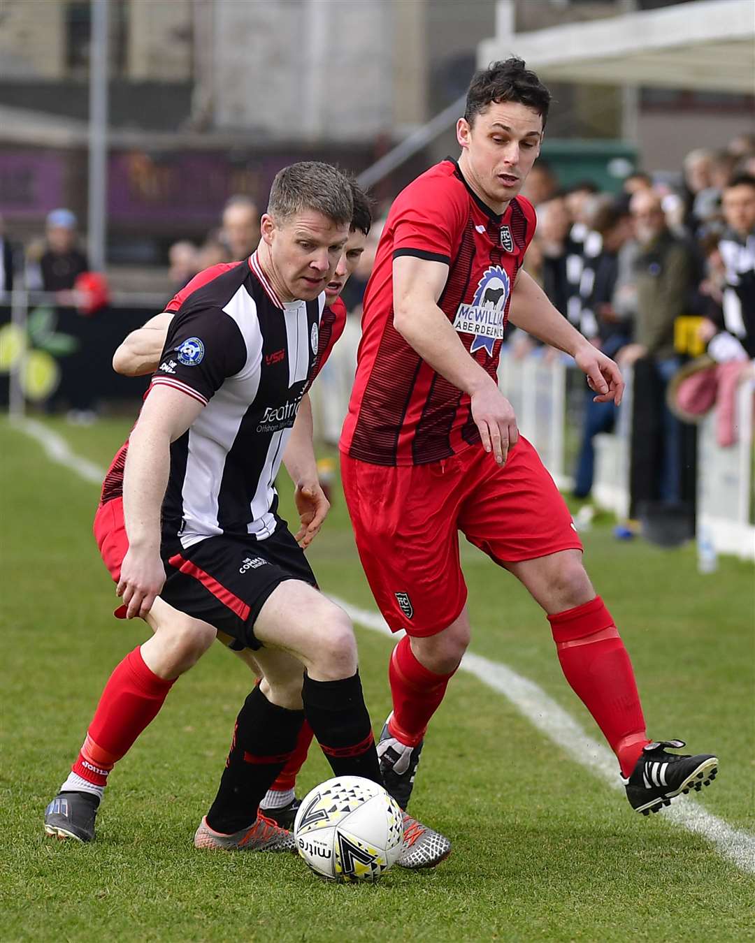 Wick's Davie Allan on ball under pressure from Fraserburgh's Ryan Sargent and Grant Campbell