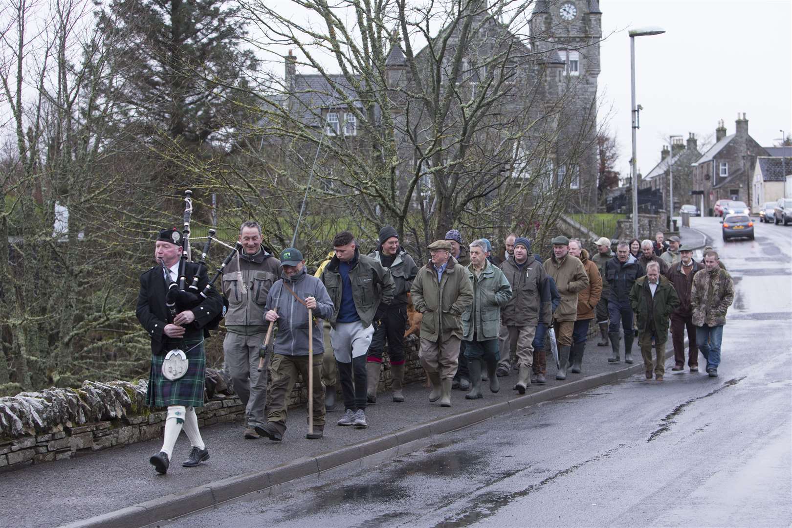 Piper Alasdair Miller leads anglers over Halkirk Bridge towards the River Thurso for the opening of the salmon season on Saturday morning. Picture: Robert MacDonald / Northern Studios