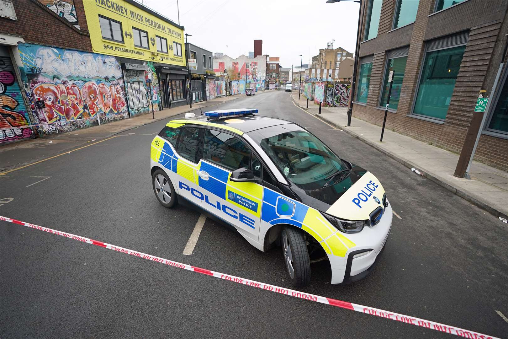 A police car near the scene at White Post Lane, Hackney Wick, east London, after two men were stabbed in the early hours of Saturday morning (James Manning/PA)