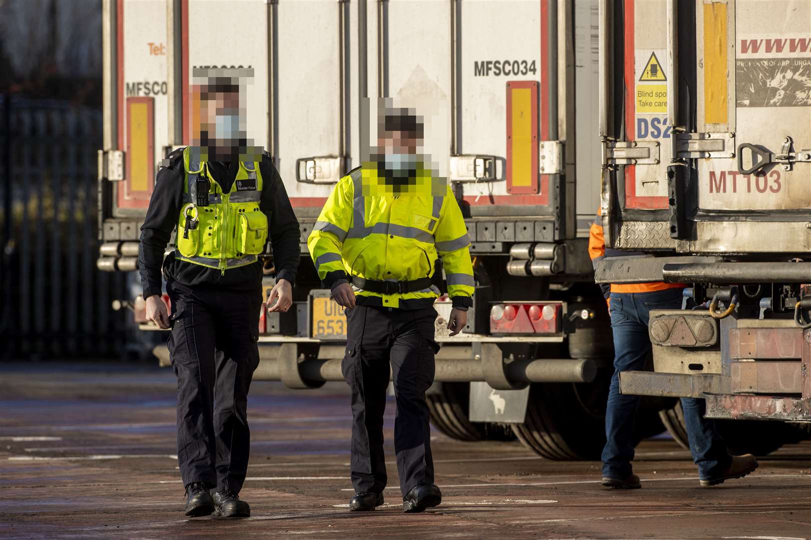 UK Border Force officers on duty at a checking facility at Belfast Port (PA)