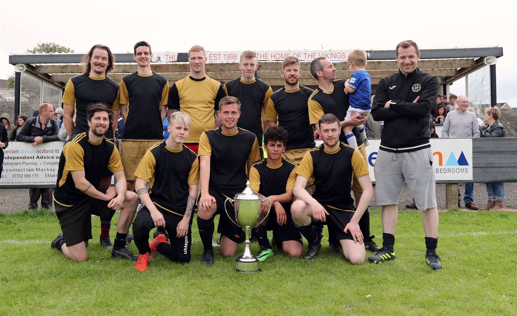 John Maclean (extreme right) and the Maclean family select team with the seven-a-side winners' trophy. Picture: James Gunn