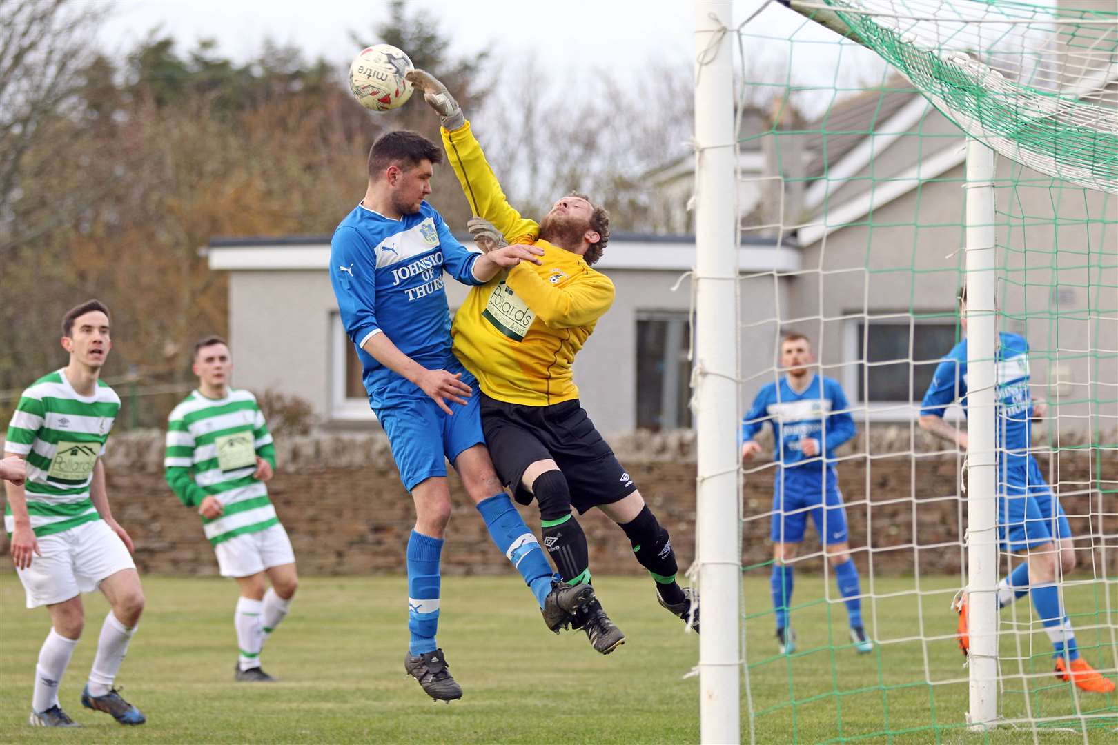 Castletown goalie Lee Kirk saves from Thurso Acks' Scott Bell during a county league first division match in April 2019. Picture: James Gunn