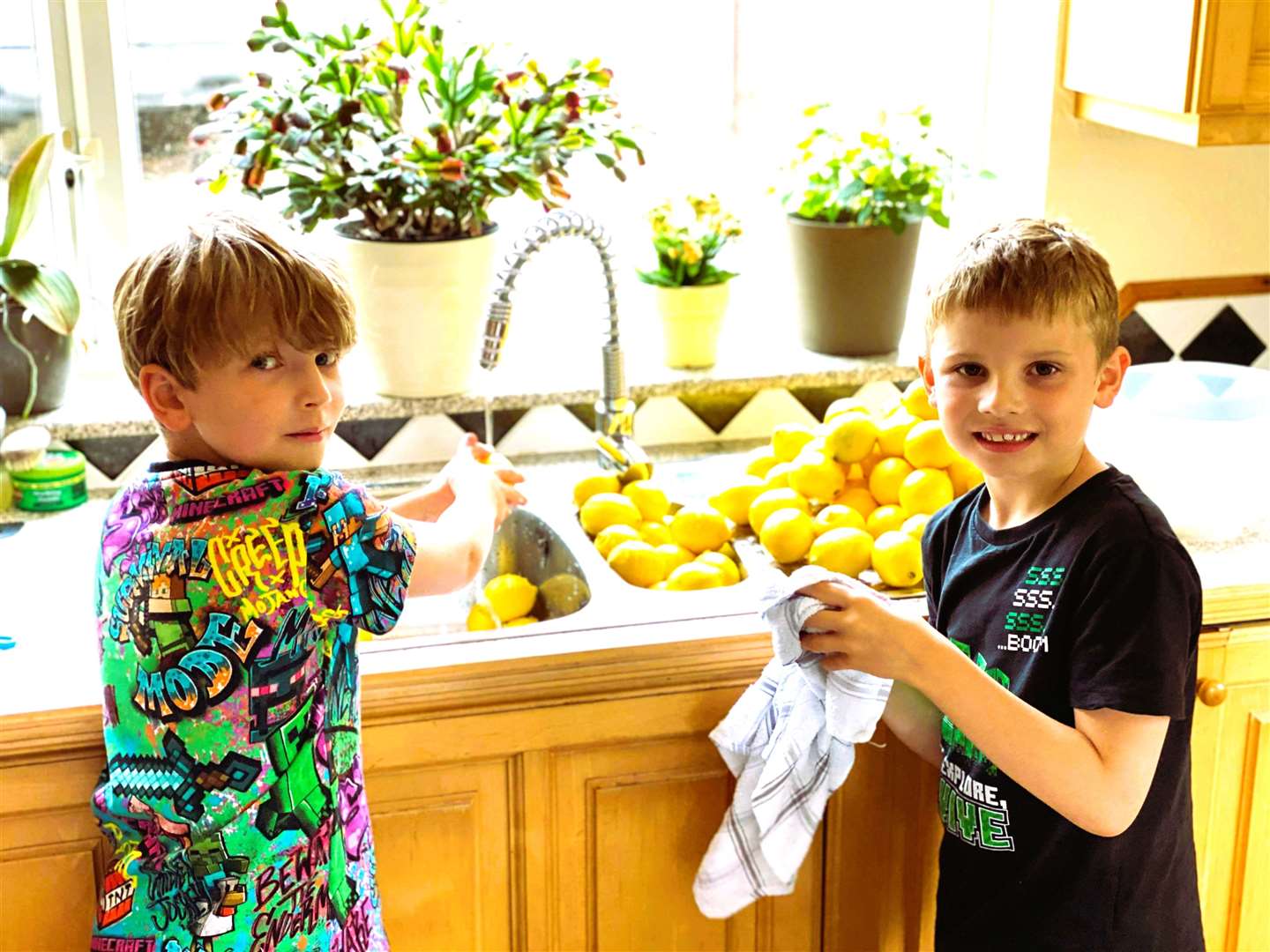 Ollie Hall, at left, with his brother Sammie prepare the recipe for the lemonade.