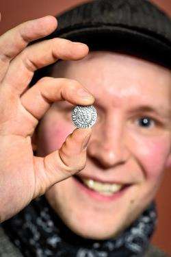 Mikie Aitken shows off one of the coins he found. Photo: Angus Mackay Photography.