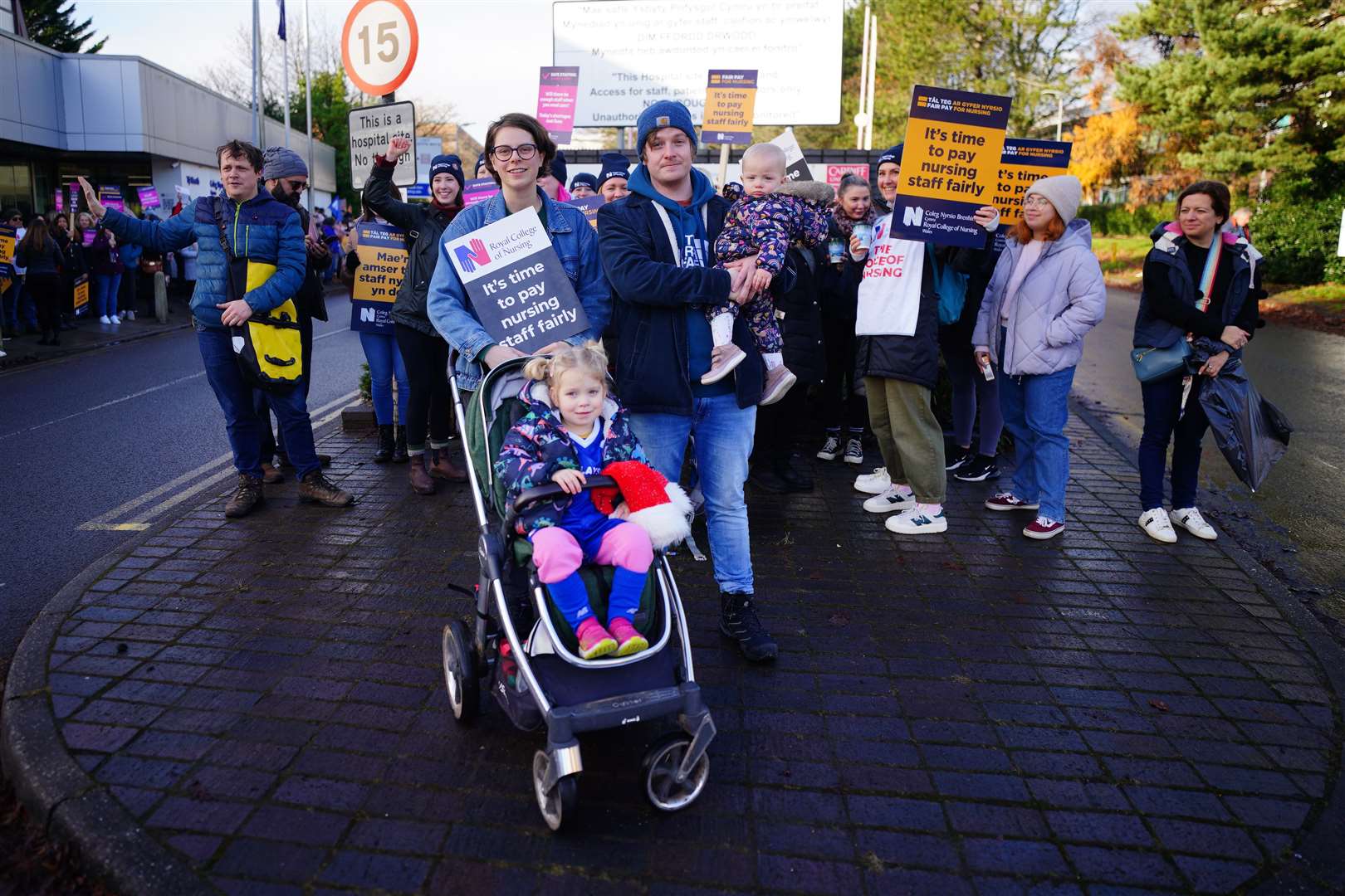 Georgia Sheppard and partner Lewis Wicks with their children Cassie, three, and one-year-old Tilly join members of the RCN in Cardiff (Ben Birchall/PA)