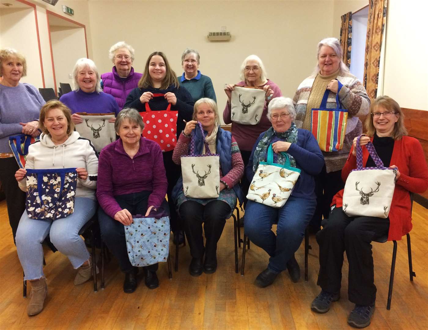 Members of Murkle SWI displaying the tote bags they made at their monthly meeting.