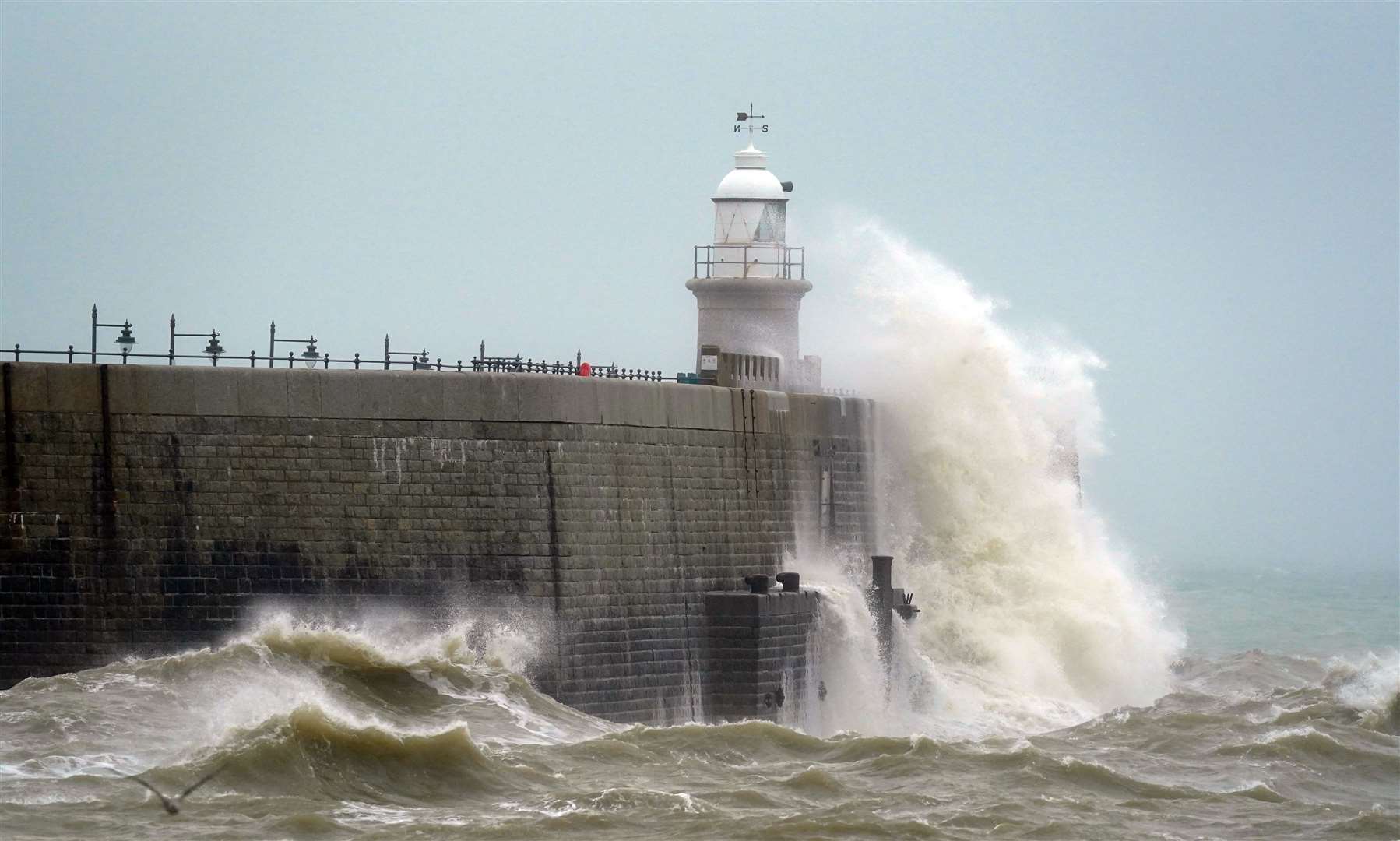 Waves crash over the harbour arm during bad weather in Folkestone, Kent (Gareth Fuller/PA)