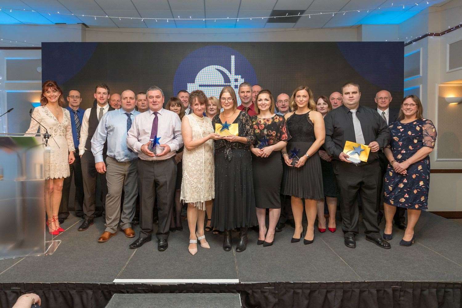 Winners of the Decommissioning Excellence Awards with presenter and host Nicky Marr (far left).