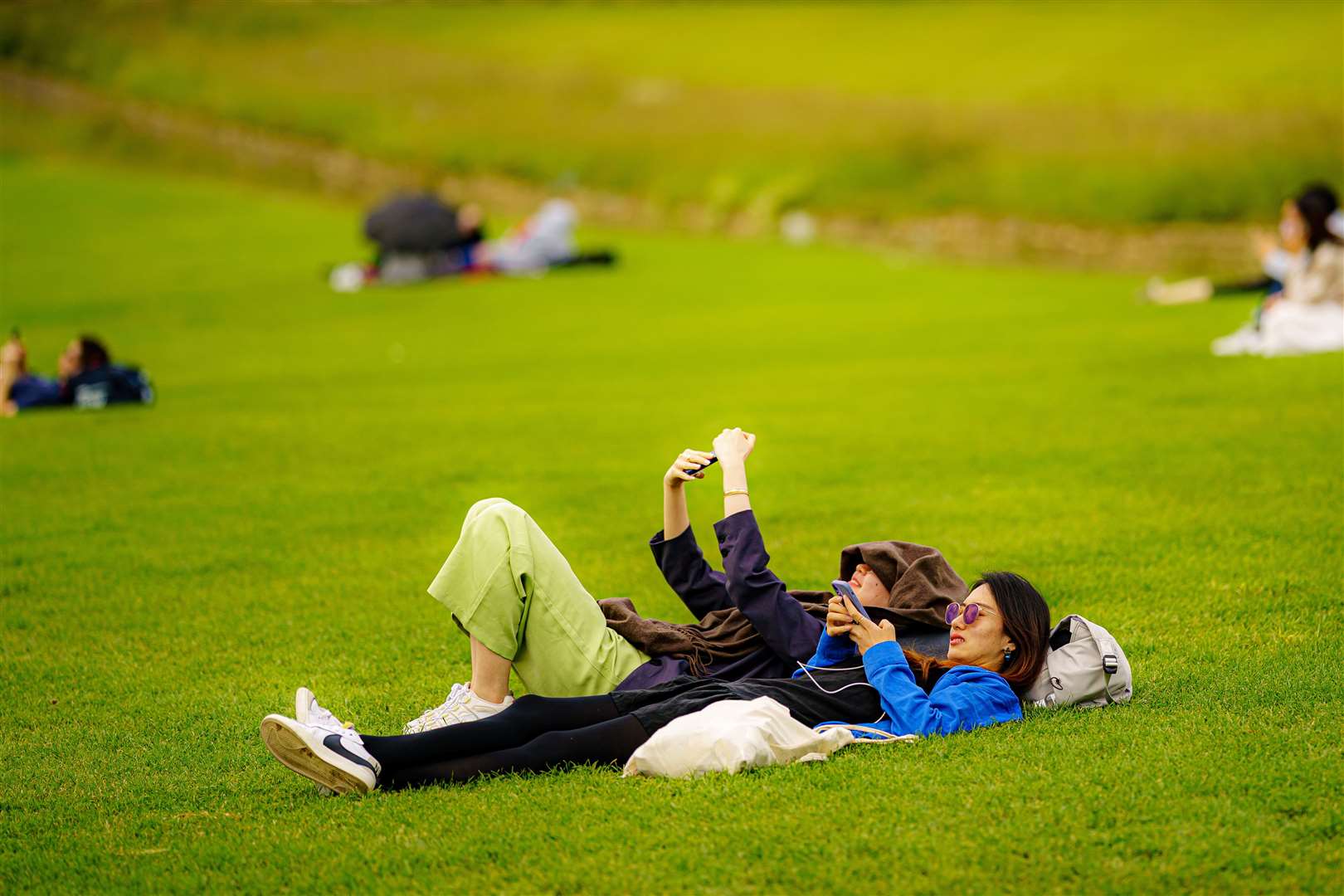 People relax in the sun on the grass at the Royal Crescent, Bath (Ben Birchall/PA)