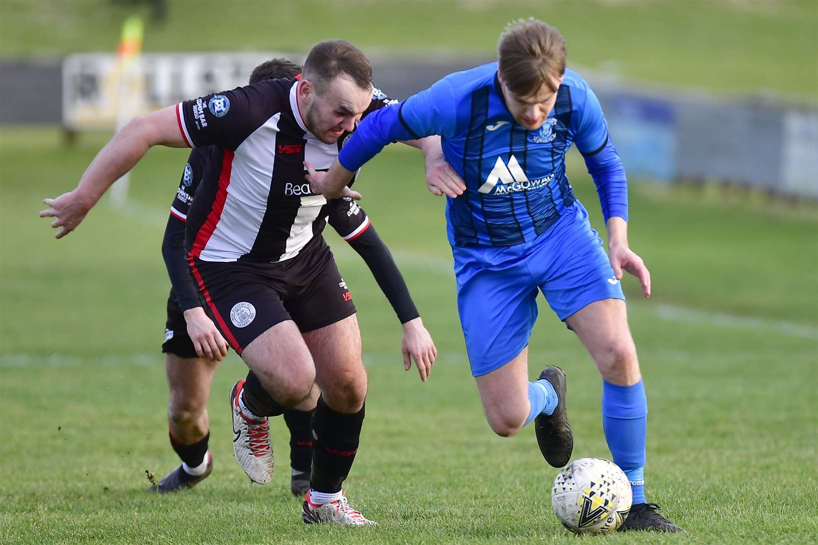 Strathspey Thistle's Michael McKenzie is challenged by Owen Harrold during Wick Academy's 3-2 win last Saturday. Picture: Mel Roger