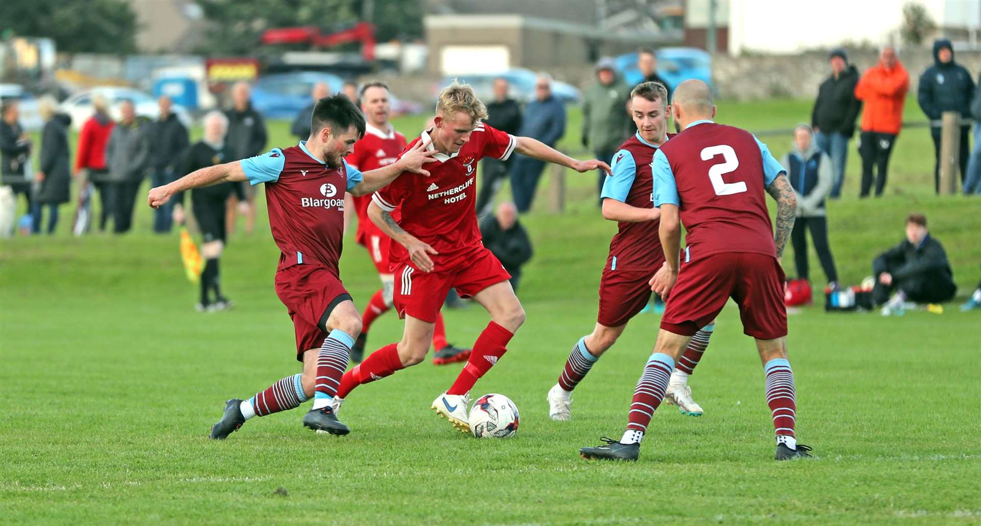 Michael Steven of Wick Groats tries to weave his way through the Pentland United defence. Picture: James Gunn